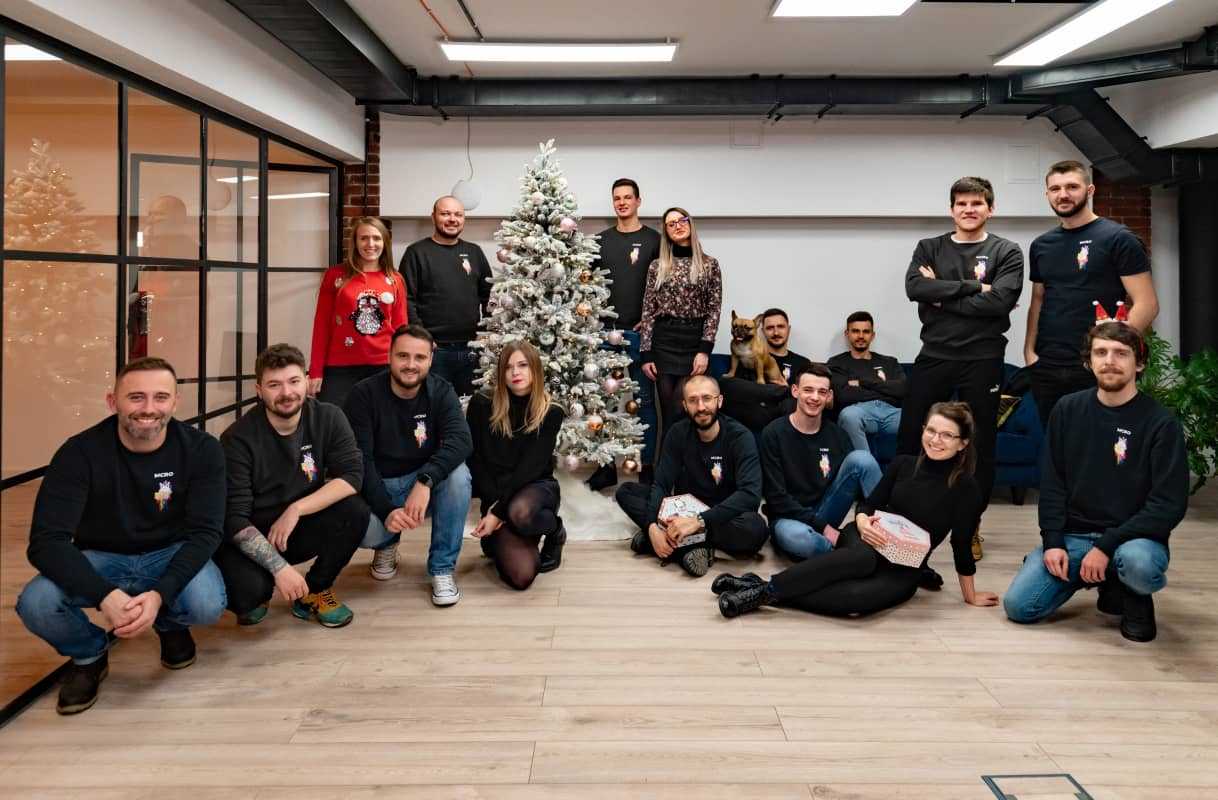 Group of people sitting next to a Christmas tree